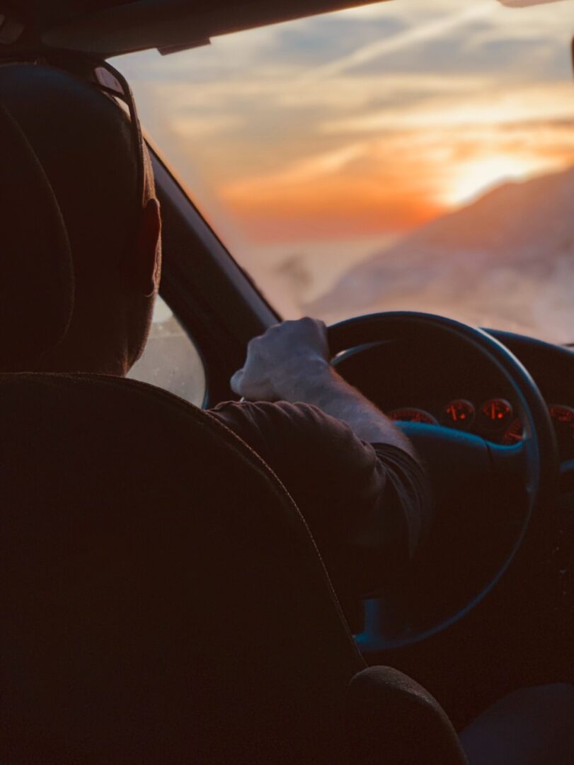 Man driving at sunset
